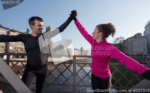 Image of couple warming up before jogging