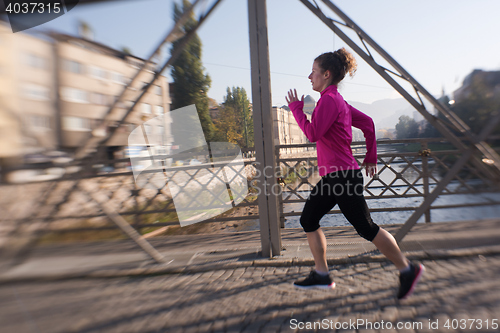 Image of sporty woman jogging on morning