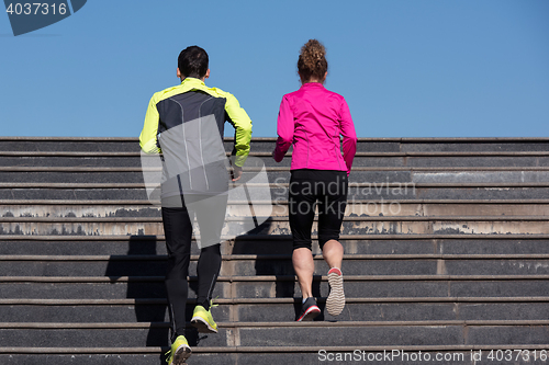 Image of young  couple jogging on steps