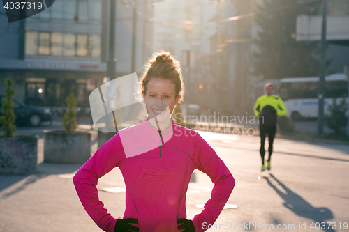 Image of woman  stretching before morning jogging