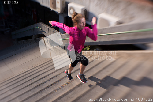 Image of woman jogging on  steps