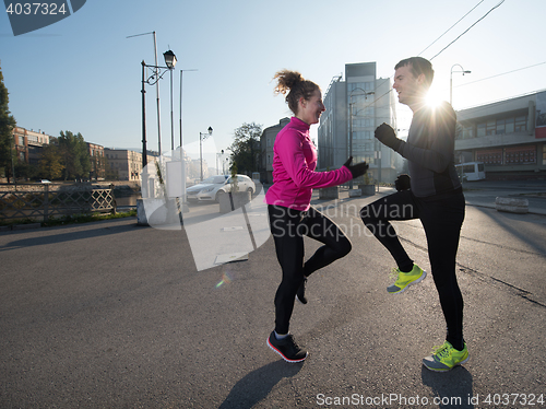 Image of couple warming up before jogging