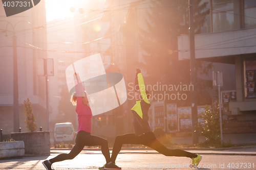 Image of couple warming up before jogging