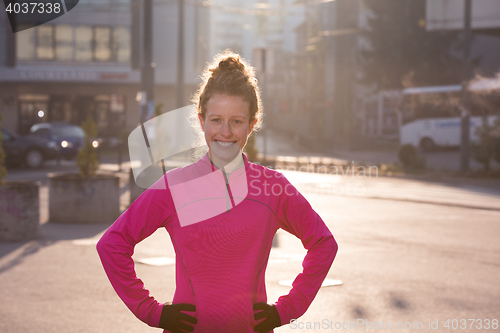 Image of woman  stretching before morning jogging