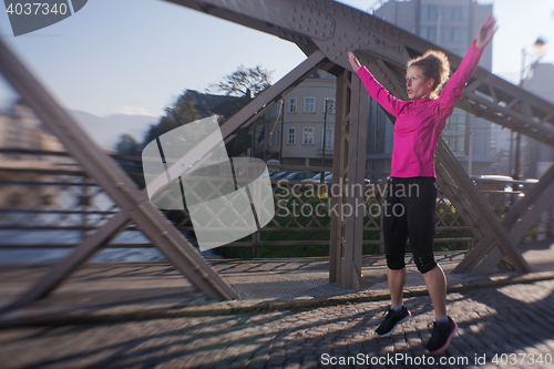 Image of woman  stretching before morning jogging