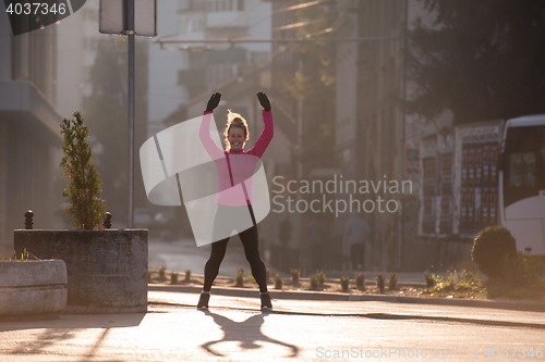 Image of woman  stretching before morning jogging