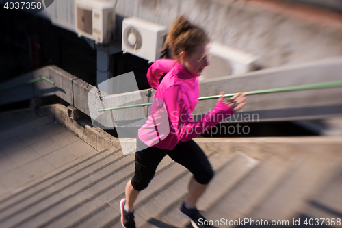 Image of woman jogging on  steps