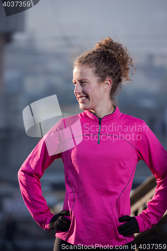 Image of woman  stretching before morning jogging