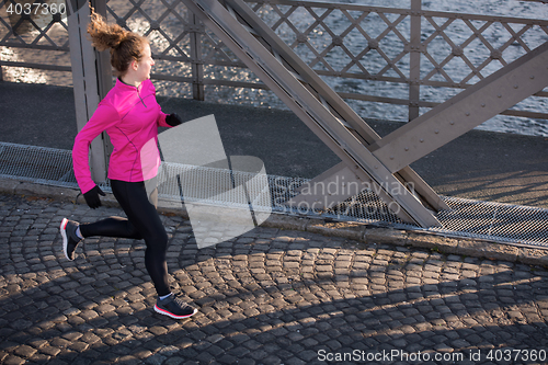 Image of sporty woman jogging on morning