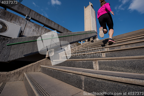 Image of woman jogging on  steps