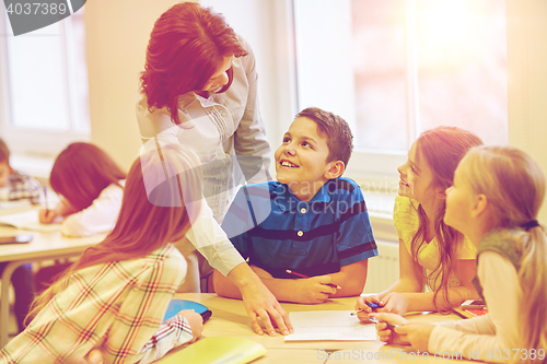 Image of group of school kids writing test in classroom