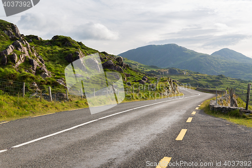 Image of asphalt road and hills at connemara in ireland