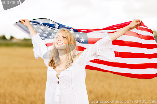Image of happy woman with american flag on cereal field