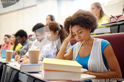 Image of group of students with coffee writing on lecture