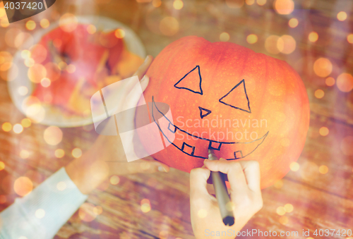 Image of close up of woman with pumpkins at home