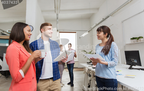 Image of creative team with tablet pc and papers at office