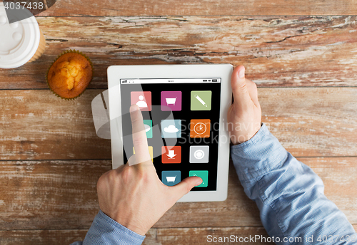 Image of close up of hands with menu icons on tablet pc