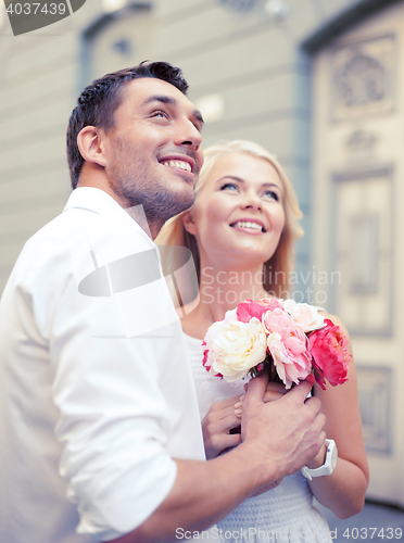Image of couple with flowers in the city