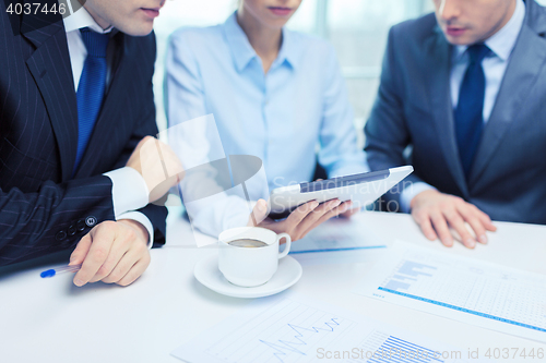 Image of business team with graph, tablet pc and coffee