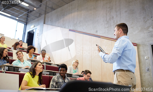 Image of students and teacher with tablet pc at lecture