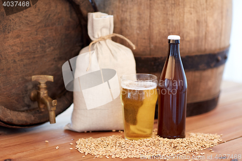 Image of close up of beer barrel, glass, bottle and malt