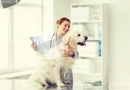 Image of happy doctor with retriever dog at vet clinic