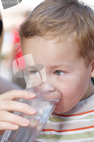 Image of Little boy drinkng a glass of fresh water