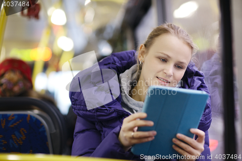 Image of Woman with touchpad in the bus