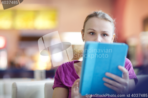 Image of Woman in a terminal using her tablet