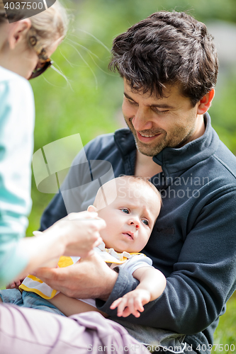 Image of Mom and dad caring for baby