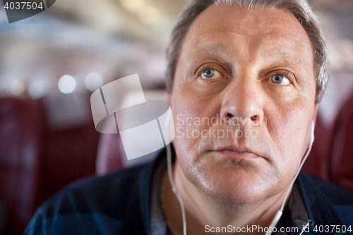 Image of Music makes him to relax during the flight