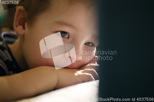 Image of Boy watching cartoons on touchpad