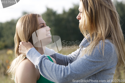 Image of Two sisters or female friends in a close embrace