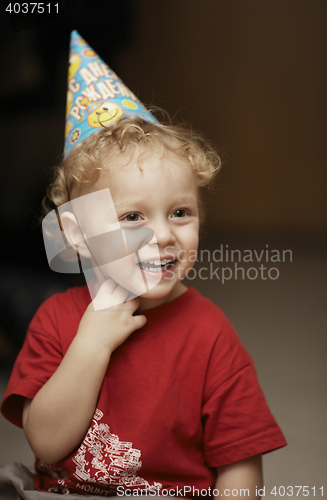 Image of Cute happy young boy in a party hat