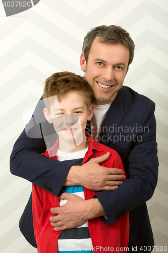 Image of Happy father embracing son