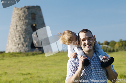 Image of Happy young father and son playing together