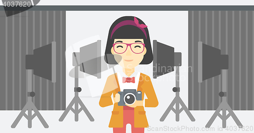 Image of Smiling photographer holding camera.