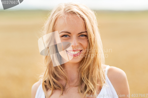 Image of smiling young woman in white on cereal field