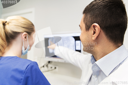 Image of close up of dentist and assistant at dental clinic