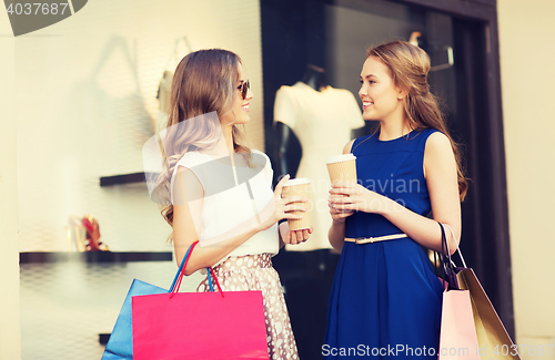 Image of young women with shopping bags and coffee at shop