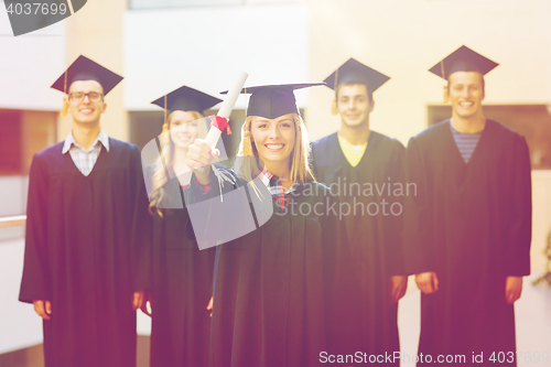 Image of group of smiling students in mortarboards