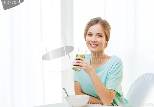 Image of happy woman having breakfast at home