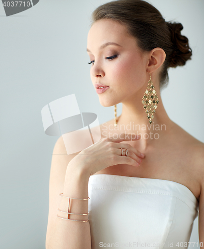 Image of beautiful asian woman with earrings and bracelet