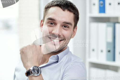 Image of portrait of smiling businessman in office