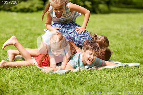 Image of happy kids playing and having fun in summer park