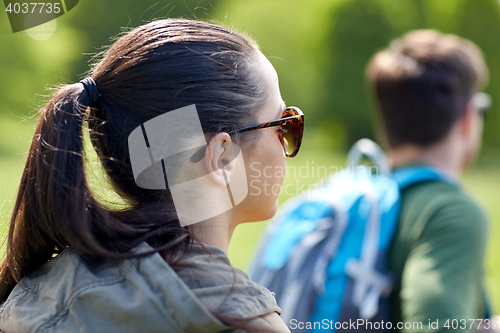 Image of close up of couple with backpacks hiking outdoors