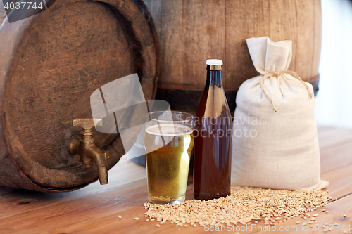 Image of close up of beer barrel, glass, bottle and malt