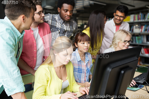 Image of international students with computers at library
