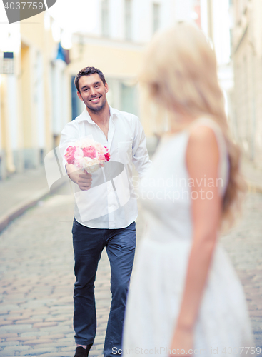 Image of couple with flowers in the city