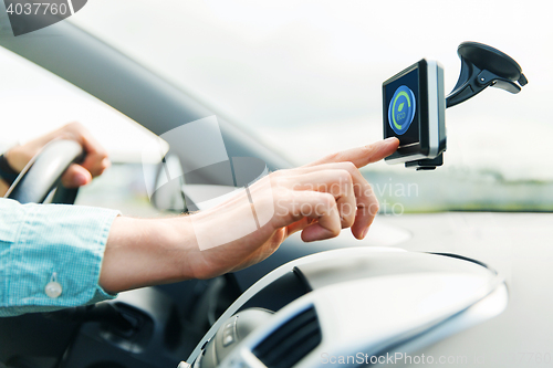 Image of close up of man with gadget on screen driving car